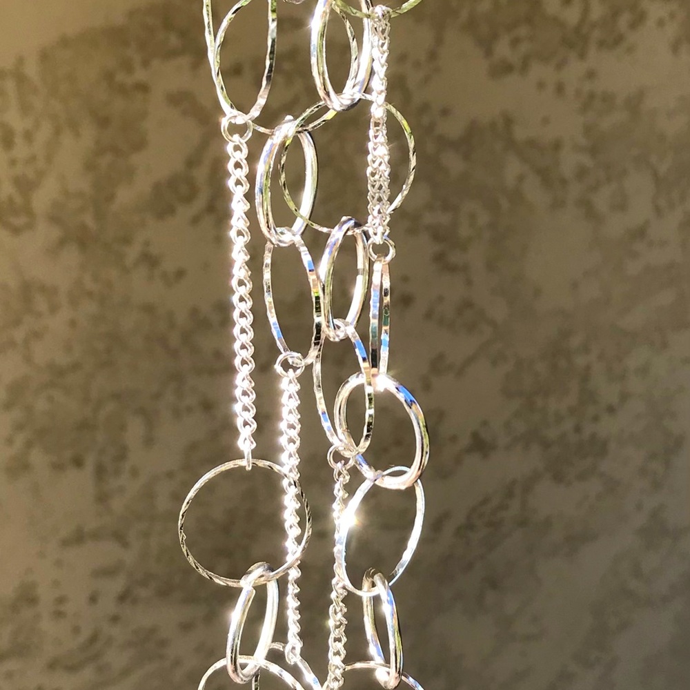 Silver colored metal circle necklace, approx. 20” long, very sparkly, new cond.